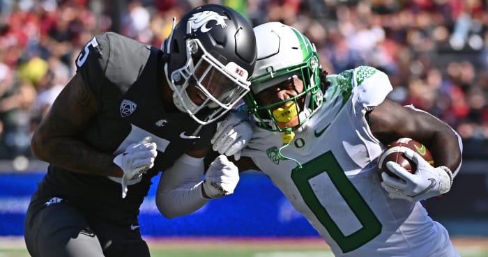 Oregon Running back Bucky Irving fighting for extra yards against the Cougars defense.
